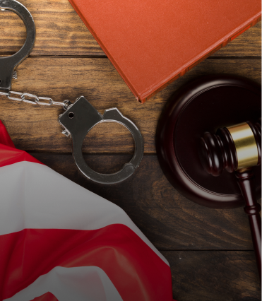 handcuffs, a gavel, and the american flag
